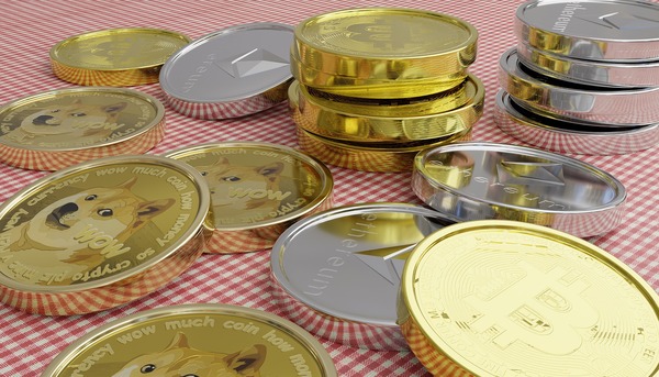 Assorted cryptocurrency coins including Dogecoin, Ethereum and Bitcoin on a checkered surface