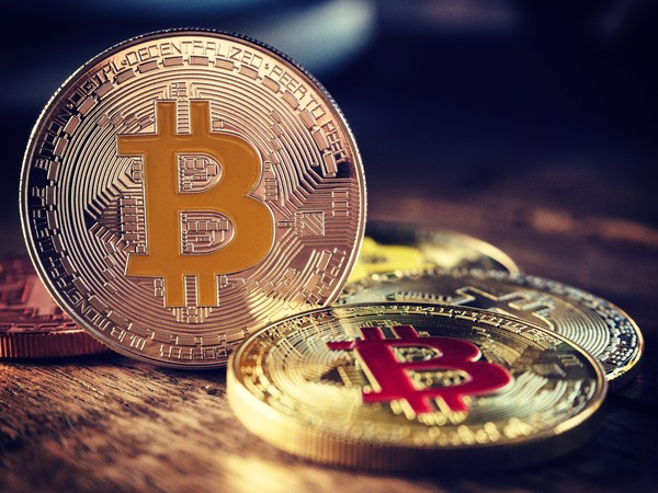 Close-up of Bitcoin coins on a wooden surface